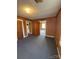 Room featuring natural light and wood paneling, and doorway into other rooms at 701 Betty St, Gastonia, NC 28054