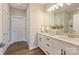 Bright bathroom featuring double vanity, modern fixtures, granite countertops, and wood-look floors at 8029 Joy Crossing Ln, Charlotte, NC 28214