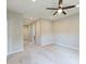 Bright bedroom with plush carpet, ceiling fan, and multiple doors at 8029 Joy Crossing Ln, Charlotte, NC 28214