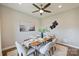 Dining room featuring a modern table set for six, stylish decor, and a ceiling fan at 8029 Joy Crossing Ln, Charlotte, NC 28214