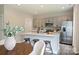 Modern kitchen with stainless steel appliances, gray cabinetry, and a breakfast bar with seating at 8029 Joy Crossing Ln, Charlotte, NC 28214