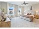 Spacious main bedroom with two large windows, a stylish bed, and soft carpeting at 8029 Joy Crossing Ln, Charlotte, NC 28214