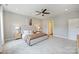 Large main bedroom featuring a luxurious upholstered headboard, plush carpet, and neutral décor at 8029 Joy Crossing Ln, Charlotte, NC 28214
