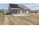 A large backyard with a patio, screened in porch and solar panels on the back of the house at 815 Foxmeade Ct, Salisbury, NC 28144