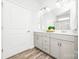 Bright bathroom features double sinks, gray cabinets, a glass-enclosed shower and wood-look flooring at 815 Foxmeade Ct, Salisbury, NC 28144