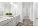 Bathroom featuring double vanity sinks, modern fixtures, and hardwood floors at 815 Foxmeade Ct, Salisbury, NC 28144