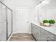 Bright bathroom features double sinks, gray cabinets, a glass-enclosed shower and wood-look flooring at 815 Foxmeade Ct, Salisbury, NC 28144