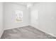 Neutral bedroom features plush carpeting, a window for natural light, and a white door at 815 Foxmeade Ct, Salisbury, NC 28144