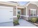 Up-close view of the charming home entrance, with a welcoming wreath, brick accents and a two-car garage at 815 Foxmeade Ct, Salisbury, NC 28144