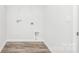 Spacious laundry room with washer/dryer hookups and wood-look flooring at 815 Foxmeade Ct, Salisbury, NC 28144