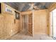 Interior of shed with plywood walls, metal roof, decorative fixtures and air conditioner at 815 Foxmeade Ct, Salisbury, NC 28144