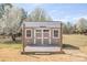 Exterior of shed with covered porch and white trim on doors and windows at 815 Foxmeade Ct, Salisbury, NC 28144