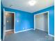 Bright bedroom featuring a closet, carpeted floors, and blue walls in a well-lit, comfortable space at 82 22Nd Nw Ave, Hickory, NC 28601