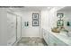 Bathroom featuring double sinks, quartz countertop, decorative plants, framed mirrors, and a glass-enclosed shower at 894 Two Brothers Ln, York, SC 29745