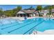 View of community pool and clubhouse surrounded by trees in the background at 894 Two Brothers Ln, York, SC 29745