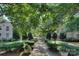 Beautifully landscaped courtyard entrance features lush greenery, mature trees, and an inviting walkway at 1121 Myrtle Ave # 24, Charlotte, NC 28203