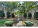 Well-manicured courtyard entrance welcomes residents with manicured hedges and stone pathway at 1121 Myrtle Ave # 24, Charlotte, NC 28203