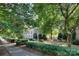 Attractive building facade with mature trees and lush landscaping along sidewalk at 1121 Myrtle Ave # 24, Charlotte, NC 28203