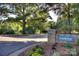 Freedom Park entrance featuring stone signage, landscaped flower beds, and mature trees at 1121 Myrtle Ave # 24, Charlotte, NC 28203