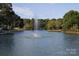 Scenic pond view with a water fountain, lush greenery, and serene water reflecting the sky at 1121 Myrtle Ave # 24, Charlotte, NC 28203