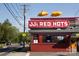 JJ's Red Hots featuring vibrant signage, outdoor seating, and a lively atmosphere in a bustling location at 1121 Myrtle Ave # 24, Charlotte, NC 28203