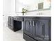 Bathroom boasts a spacious black vanity with double sinks and white countertops atop mosaic tile flooring at 11215 Idlewild Rd, Matthews, NC 28105