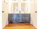 Bathroom with a double sink vanity, granite countertops, and wood cabinets at 11215 Idlewild Rd, Matthews, NC 28105