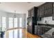 Kitchen featuring black cabinets and a stainless steel refrigerator at 11215 Idlewild Rd, Matthews, NC 28105