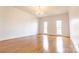 Large living room with hardwood floors, crown molding, and many windows for natural light at 11215 Idlewild Rd, Matthews, NC 28105