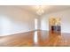 Open living room featuring hardwood floors and an adjacent bathroom at 11215 Idlewild Rd, Matthews, NC 28105