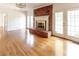 Bright living room with brick fireplace, hardwood floors, and french doors at 11215 Idlewild Rd, Matthews, NC 28105