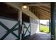 Rustic horse stable with open stalls, wood beams, and a connected corridor to pasture at 11215 Idlewild Rd, Matthews, NC 28105