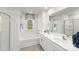 Bright bathroom featuring a tub, large mirror, and double vanity with white countertops and cabinets at 125 Meadow View Dr, Statesville, NC 28677