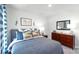 Bright bedroom with a comfortable bed, soft lighting, and a chest of drawers at 125 Meadow View Dr, Statesville, NC 28677