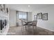 A dining area with a modern table and chairs illuminated by natural light from the window at 127 Meadow View Dr, Statesville, NC 28677