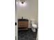 Modern powder room with a vanity, black accents, and stylish tile flooring at 1370 Coppergate Dr, Salisbury, NC 28147