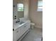 Well-lit bathroom featuring a sleek white vanity, tile flooring, and modern fixtures at 1370 Coppergate Dr, Salisbury, NC 28147