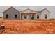 New construction home featuring a modern design with gray and white siding, and a covered front porch at 1370 Coppergate Dr, Salisbury, NC 28147