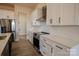A modern kitchen featuring stainless steel appliances, white cabinetry, and solid surface countertops at 1370 Coppergate Dr, Salisbury, NC 28147
