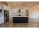 Modern kitchen with white cabinets, stainless steel appliances, and a large central island at 1370 Coppergate Dr, Salisbury, NC 28147