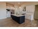 A bright open kitchen featuring a large center island, stainless appliances, and shaker-style cabinets at 1370 Coppergate Dr, Salisbury, NC 28147