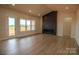 Living room featuring hardwood floors, lots of light, and a modern black fireplace at 1370 Coppergate Dr, Salisbury, NC 28147