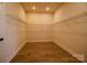 Spacious walk-in closet with wire shelving and wood-look vinyl floors offers ample storage at 1370 Coppergate Dr, Salisbury, NC 28147