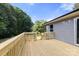 Newly built wood deck with stairs and railings off the back of the home at 141 Lakewind Dr, Mooresville, NC 28115