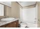 A bathroom with dark wood cabinets, a white sink and a shower/tub combo at 141 Lakewind Dr, Mooresville, NC 28115