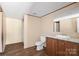 Bathroom featuring a single vanity with ample cabinet space and a clean, functional toilet, designed for convenience at 141 Lakewind Dr, Mooresville, NC 28115