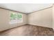 Cozy bedroom with wood-look floors and natural light, offering a peaceful retreat for rest and relaxation at 141 Lakewind Dr, Mooresville, NC 28115