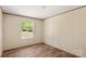 Bright bedroom with wood-look floors and natural light, providing a cozy space for rest and relaxation at 141 Lakewind Dr, Mooresville, NC 28115