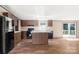 Bright kitchen with wood cabinets, island, and black appliances, offering a functional cooking space at 141 Lakewind Dr, Mooresville, NC 28115