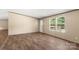 Inviting living room with wood-look floors and natural light, offering a versatile space for comfortable living and relaxation at 141 Lakewind Dr, Mooresville, NC 28115